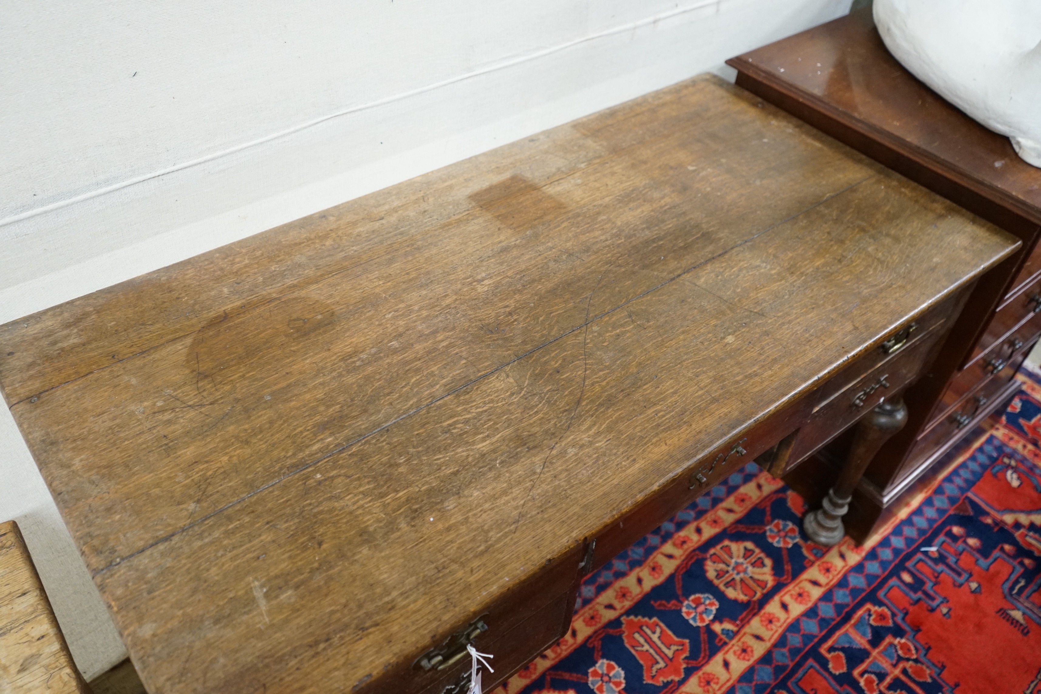 A 1920's oak kneehole desk, length 122cm, 61cm, height 76cm